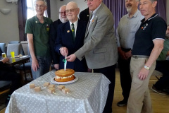 035.2025-05-17-140-years-of-the-Swanage-Branch-The-Swanage-Railway.-37-Your-Host-and-fellow-volunteers-cut-the-140-years-cake